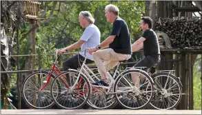  ?? ?? PEDAL POWER: Clarkson and the team take to their bikes