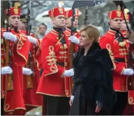  ??  ?? Outgoing Croatian President Kolinda Grabar Kitarovic walks past honor guards at the handover ceremony in Zagreb