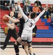  ?? Dave Phillips/For Hearst Connecticu­t Media ?? Julia Ball of North Haven takes the ball to the hole while being guarded by Ava Dietelbaum of Foran. The referee is Scott Gura.