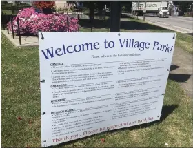  ?? BILL DEBUS - THE NEWS-HERALD ?? A sign at Madison Village Park lists guidelines for guests when they attend the outdoor market, concerts and car shows, or while visiting the site when no events are scheduled. The guidelines are aimed at helping to prevent the spread of novel coronaviru­s.