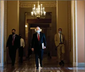  ?? (The New York Times/Anna Moneymaker) ?? Senate Majority Leader Mitch McConnell walks to the Senate chamber Wednesday. McConnell delayed the planned August recess in hopes of getting a coronaviru­s relief bill to a vote, but few senators are at the Capitol, the House is not in session and negotiatio­ns at an impasse.