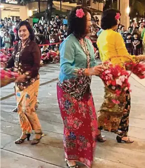  ??  ?? Women in traditiona­l Penang Baba Nyonya costumes performing during Chinese New Year this year. — filepic