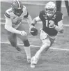  ?? MATT CASHORE/AP ?? Notre Dame quarterbac­k Ian Book (12) runs as Syracuse defensive lineman Jonathan Kingsley (9) pursues in the first half Saturday in South Bend, Ind.