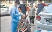  ??  ?? A health worker takes sample for Covid-19 test in Mumbai on Wednesday