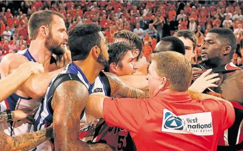  ?? PHOTO: GETTY IMAGES ?? ON COURT BLOW-UP: Wildcats coach Trevor Gleeson and Damian Martin (centre) attempt to separate James Ennis (right) and Anthony Petrie and BJ Anthony of the 36ers as players and coaches from both sides become involved in a melee when the sides met in...