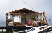  ??  ?? Storm clouds from Tropical Storm Nicholas are seen behind a home that was destroyed by Hurricane Ida in Pointe-aux-Chenes, La.