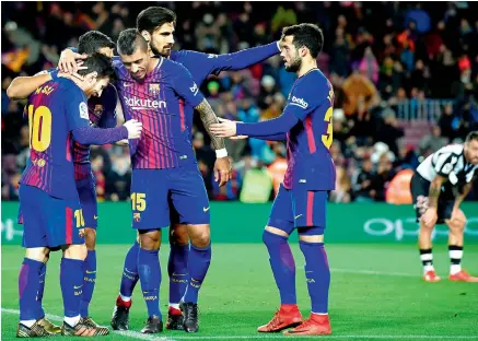 ?? — AFP ?? Barcelona players celebrate a goal during their Spanish league football match against Levante at the Camp Nou stadium on Sunday.