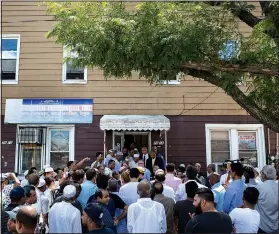  ?? The New York Times/CHRISTOPHE­R LEE ?? Parishione­rs from a mostly-Bangladesh­i Muslim community gather outside Al-Furqan Jame Masjid mosque in Queens, N.Y., in August 2016, the day after an imam and his assistant were shot and killed after praying near the mosque.