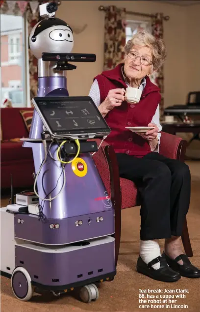 ??  ?? Tea break: Jean Clark, 86, has a cuppa with the robot at her care home in Lincoln