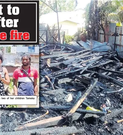  ?? CONTRIBUTE­D PHOTOS ?? Christine Richards (centre) with two of her children Tameka and Oral Clarke.
Rubble is all that’s left of Christine Richards’ home after a fire on Christmas Eve 2021.