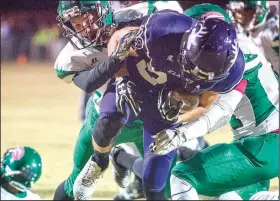  ?? NWA Democrat-Gazette/CHARLIE KAIJO ?? Elkins running back Chance Jones (center) tries to power through Greenland defenders Friday in Elkins.