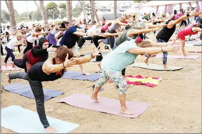  ??  ?? Lebanese men and women take part in the fourth edition of the ‘Khod Nafas’ (take a breath) Yoga Festival in the capital Beirut on Sept
16. (AFP)