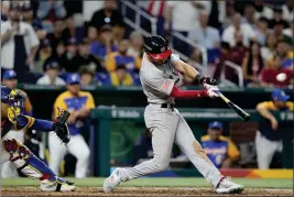 ?? WILFREDO LEE – THE ASSOCIATED PRESS ?? Trea Turner of the United States hits a go-ahead grand slam during the eighth inning of Saturday's World Baseball Classic quarterfin­al game against Venezuela in Miami.