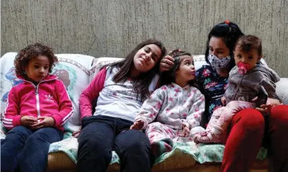  ??  ?? Sisters from Sao Paulo state, Brazil who have lost their mother, father and grandfathe­r to Covid-19. Photograph: Sebastião Moreira/EPA