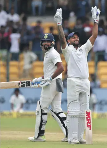  ?? AP ?? Murali Vijay, left, took time to settle in coming back into the India team and scored a century, while Shikhar Dhawan reached his milestone quickly before lunch on the first day of the Test