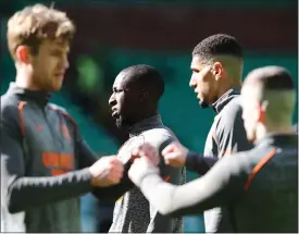  ??  ?? Connor Goldson and Scott Brown share a fist bump before kick-off, while below Glen Kamara warms up