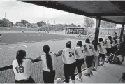  ?? [PHOTO BY DOUG HOKE, THE OKLAHOMAN] ?? Southeast players look toward the field from the bench on Tuesday. The Spartans played their first game at a new oncampus softball facility.