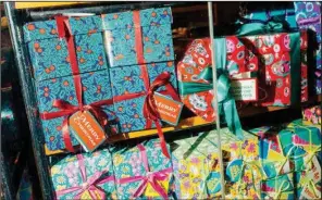  ?? (The New York Times/Jutharat Pinyodoony­achet) ?? Wrapped holiday gifts are seen in a window display in New York. The pandemic disrupted the holidays last year. Think twice before giving cash, be sure to offer thanks and never ask about a gift you gave but never saw again.