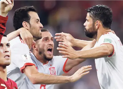  ??  ?? ABOVE: Spain’s Diego Costa (right) celebrates his side’s equalising goal during the Group B match between Portugal and Spain at the 2018 World Cup at the Fisht Stadium in Sochi, Russia, yesterday.