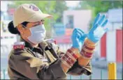  ??  ?? SAFETY FIRST: A police woman wears gloves as she stands guard ■ in Jammu on Saturday.