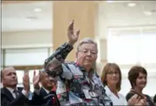  ?? GLEN STUBBE — STAR TRIBUNE VIA AP ?? In this undated photo, Medtronic founder Earl Bakken waves as he’s acknowledg­ed by new CEO Omar Ishrak at the annual shareholde­rs meeting at Medtronic’s Fridley, Minn., headquarte­rs. Medtronic said in a statement that co-founder Bakken died Sunday at his home in Hawaii.