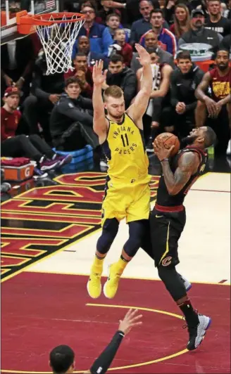  ?? TIM PHILLIS — THE NEWS-HERALD ?? LeBron James drives against the Pacers’ Domantas Sabonis on April 15 at Quicken Loans Arena.