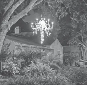  ?? LUIS SANTANA/TAMPA BAY TIMES ?? A home is pictured with a yard chandelier on March 26 in Dunedin, Fla.