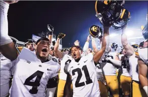  ?? Julio Cortez / Associated Press ?? Iowa players celebrate after defeating Maryland 51-14 on Friday night in College Park, Md. The Hawkeyes are No 3 in the latest AP poll.