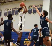  ?? OWEN MCCUE — MEDIANEWS GROUP ?? Upper Merion’s Madison Tatom, center, shoots over Pottstown’s Joneil Oister, right, during Friday’s game at Upper Merion.