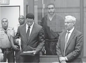  ?? HAYNE PALMOUR/AP ?? Kellen Winslow II stands behind his lawyers, Brian Watkins, left, and Harvey Steinberg, during his arraignmen­t in June.