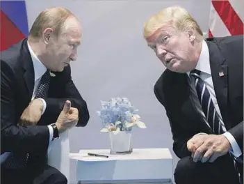  ?? Evan Vucci Associated Press ?? PRESIDENT TRUMP raised the issue of Russian interferen­ce in the U.S. election at the outset of his first face-to-face meeting with President Vladimir Putin. Both sides have different takes on the discussion.