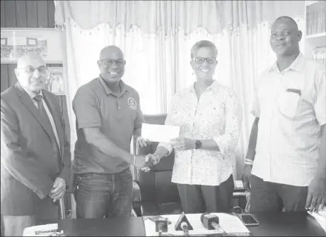  ??  ?? Vice President of the Associatio­n, Dr. Karen Pilgrim unwrapped a gift for the GBA to the tune of US$15,000 yesterday to significan­tly assist with the three-month stint on the local contingent in Cuba .