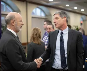  ?? Pennsylvan­ia Internet News Service ?? Daniel Greenstein, right, shakes hands with Gov. Tom Wolf after being sworn in on Jan. 16, 2019, as the fifth chancellor of the State System of Higher Education.