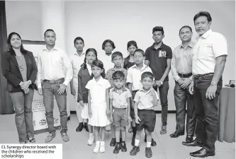  ?? ?? CL Synergy director board with the children who received the scholarshi­ps