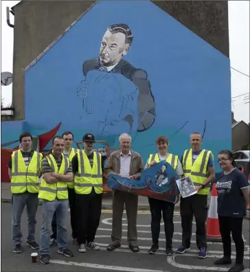  ??  ?? Work in progress: Richard Walsh, Ronan Moore, Jamie Sinnott, Paddy Berry, Sonya Weston, Eddie McGuinness and Theresa Nolan in front of the mural.