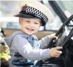  ??  ?? Clark Beeston, two, behind the wheel of a vintage Police Landrover