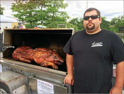  ?? FILE PHOTO ?? Brad Stevens, chef and owner of Troy-based business B-rads Catering, roasts a whole pig at a previous Troy Pig Out festival.