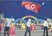  ?? ?? A man waves the national flag in the celebratio­n of 110th birth anniversar­y of late state founder Kim Il-sung, in Pyongyang.