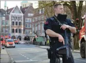  ?? ASSOCIATED PRESS ?? A POLICE OFFICER secures the crime scene after a car crashed into a group of people leaving several dead in Muenster, Germany, Saturday.