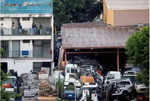  ?? — Reuters ?? a run down migrant worker dormitory next to a car junkyard. With many workers housed together, the risk of Covid-19 spreading is high and Singapore is looking to break up such clusters.