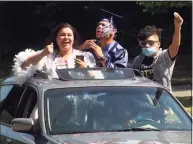  ?? Christian Abraham / Hearst Connecticu­t Media file photo ?? Graduates Miliana Herrera, left, and Ricardo Perez Santana sing as they arrive to get their diplomas during the Ansonia High School graduation in Fairfield on June 20. At right is Ricardo’s brother Leonardo Perez Santana.