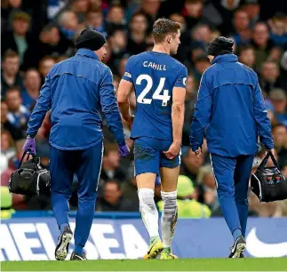  ?? CLIVE ROSE/GETTY IMAGES ?? Chelsea’s Gary Cahill leaves the pitch with medical staff with an apparent hamstring injury.