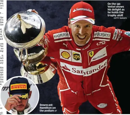 ?? AP GETTY IMAGES ?? Downcast: Hamilton on the podium On the up: Vettel shows his delight as he holds the trophy aloft