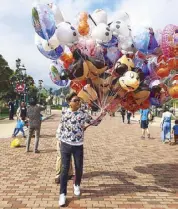  ??  ?? Don’t let it go: My day as a balloon vendor at HK Disneyland.