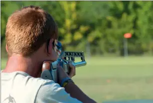  ?? RUSTY HUBBARD/THREE RIVERS EDITION ?? John Riley Wiens takes aim at a clay pigeon while shooting trap at the Remington Gun Club near Lonoke.