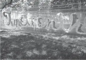  ?? BARBARA J. PERENIC/COLUMBUS DISPATCH ?? A temporary mural wall is decorated with graffiti art during the first annual Juneteenth on the Avenue on Saturday along Mount Vernon Avenue in Columbus.