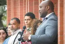  ?? JOE BURBANK/ORLANDO SENTINEL ?? Alejandro Baez, left, father of Jayden Baez, and Michael Gomez, center, who was also shot by deputies, listen to Orange-Osceola State Attorney Andrew Bain announce the grand jury’s findings.