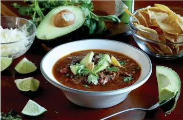  ?? Tribune News Service ?? ■ Short rib and flank steak soup sports all the luscious flavors of beefy tacos, but can be made ahead and eaten out of a bowl.