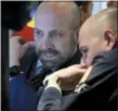  ?? RICHARD DREW — THE ASSOCIATED PRESS ?? Specialist­s James Denaro, left, and Mario Picone huddle at a trading post on the floor of the New York Stock Exchange, Wednesday.