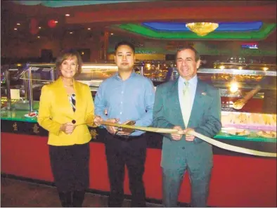  ?? Contribute­d Photo ?? GET COOKING: Han Tang Seafood &amp; Grill Buffet, 61 Washington Ave. in North Haven, recently celebrated its grand opening with a ribbon-cutting ceremony. From left are Dee Prior-Nesti, executive director Quinnipiac Chamber of Commerce; Perry Dong, owner; and North Haven First Selectman Mike Freda. The restaurant offers dining, takeout and delivery of Asian cuisine, including fresh sushi. For informatio­n, call 203-889-2450 or visit www.hantangsus­hiseafoodb­uffet.com.